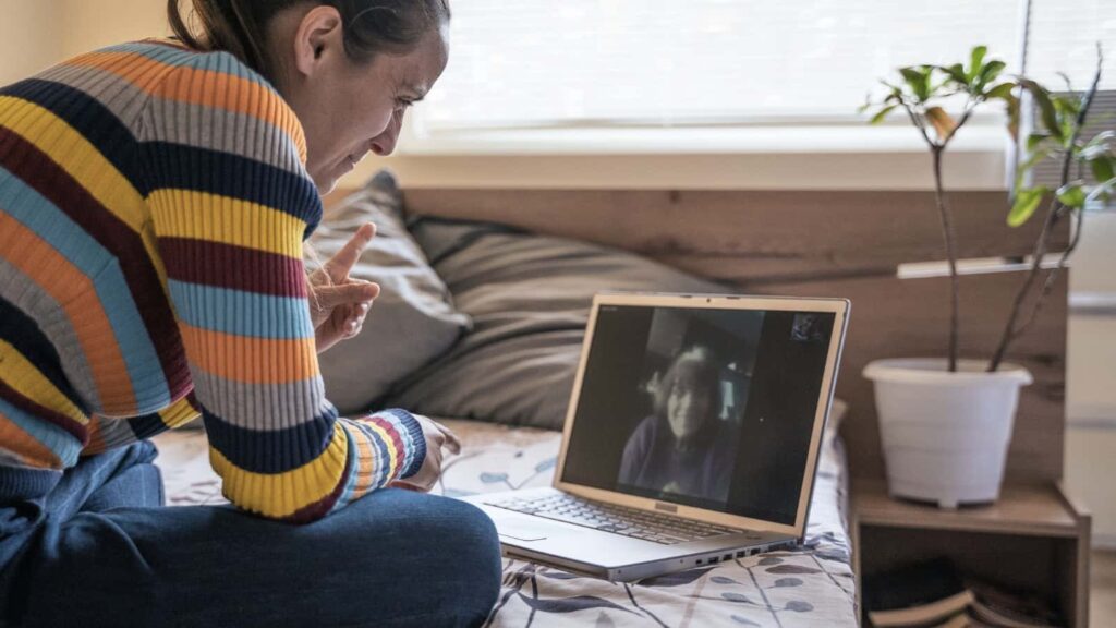 person using Zoom at home to talk to friend