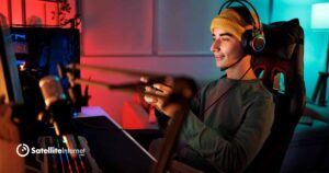 male wearing headphones and playing a video game in a colorful room