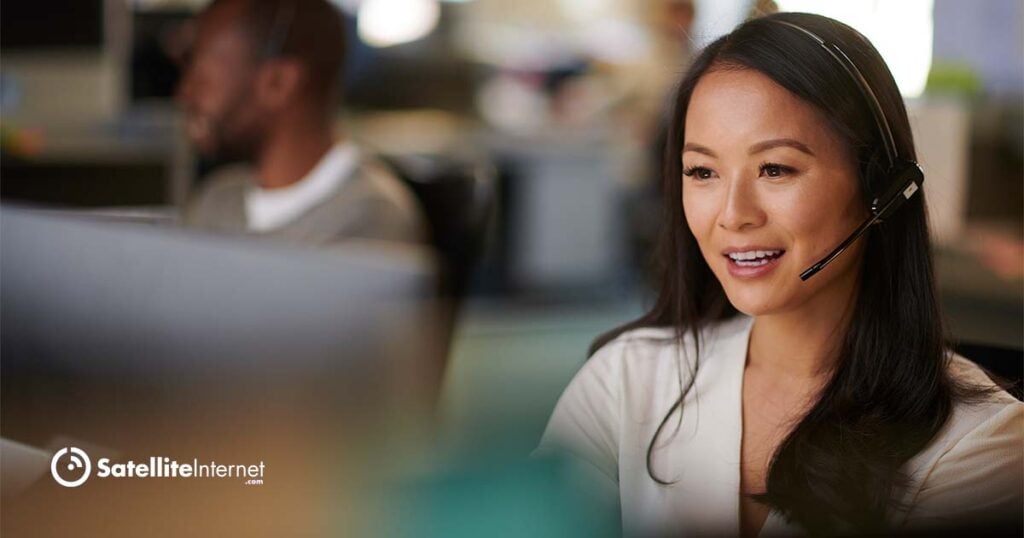 woman wearing a phone headset working in a customer service call center